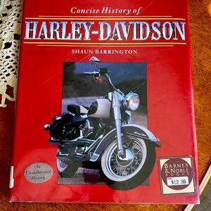 Concise History of Harley-Davidson by Shaun Barrington. Nice coffee table book.